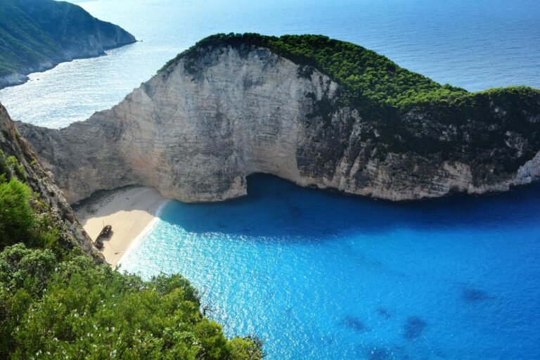 Never Run Out of Ideas: Top Tips for Generating Fresh Blog Topics A breathtaking aerial view of Navagio Beach with turquoise waters and lush greenery.