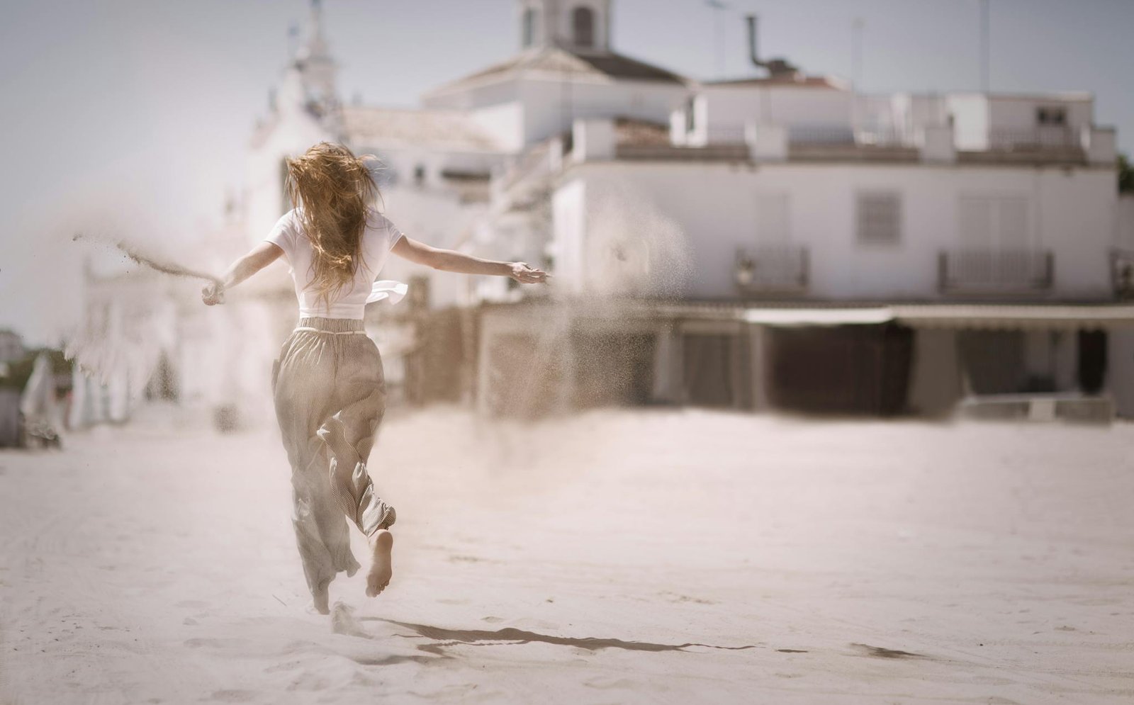 Back View Of A Young Woman Jumping